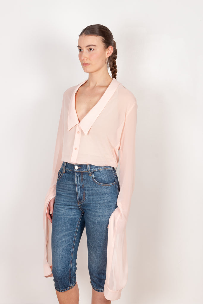 The Open Collar Shirt by Coperni is a crepe shirt with a deep collar and long sleeves meant to be tied up