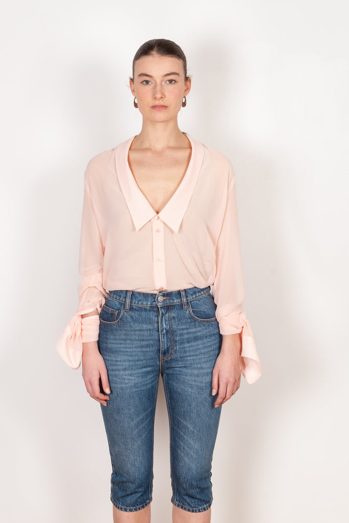 The Open Collar Shirt by Coperni is a crepe shirt with a deep collar and long sleeves meant to be tied up