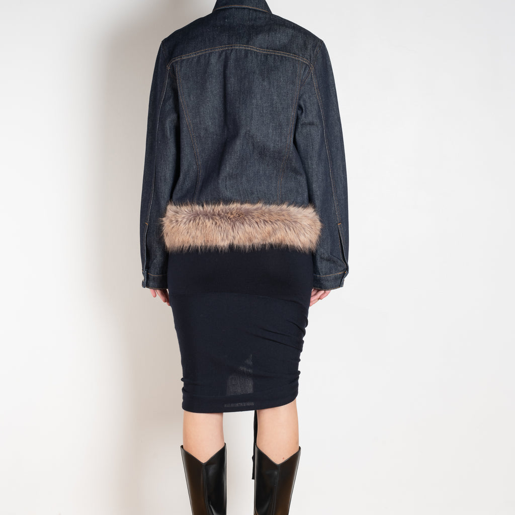 The Faux Fur Hem Denim Jacket by Coperni is a denim jacket with a faux fur waistband at the front