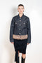 The Faux Fur Hem Denim Jacket by Coperni is a denim jacket with a faux fur waistband at the front