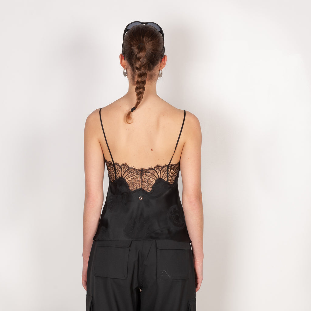 The Jacquard Cymatic Top by Coperni is a lingerie inspired silk top with a delicate scalloped lace neckline