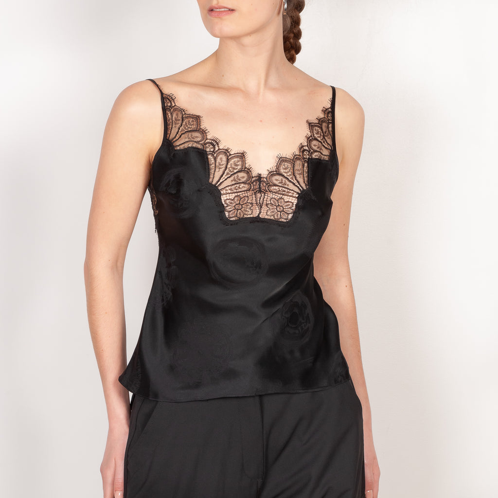 The Jacquard Cymatic Top by Coperni is a lingerie inspired silk top with a delicate scalloped lace neckline