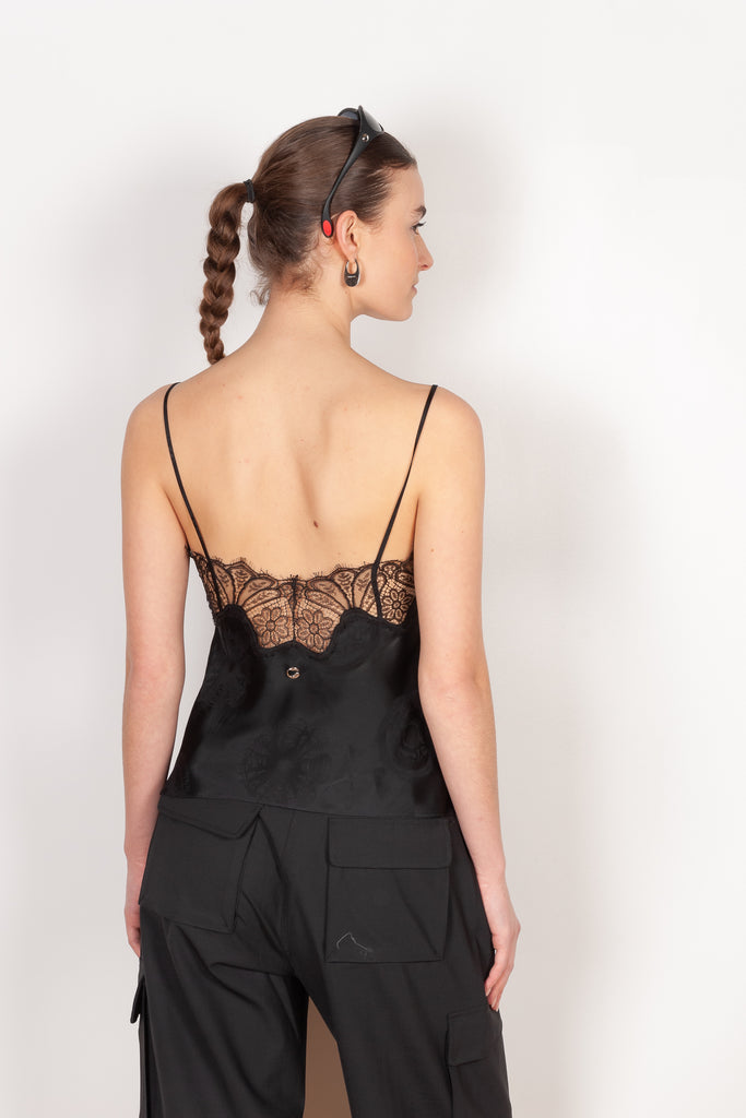 The Jacquard Cymatic Top by Coperni is a lingerie inspired silk top with a delicate scalloped lace neckline