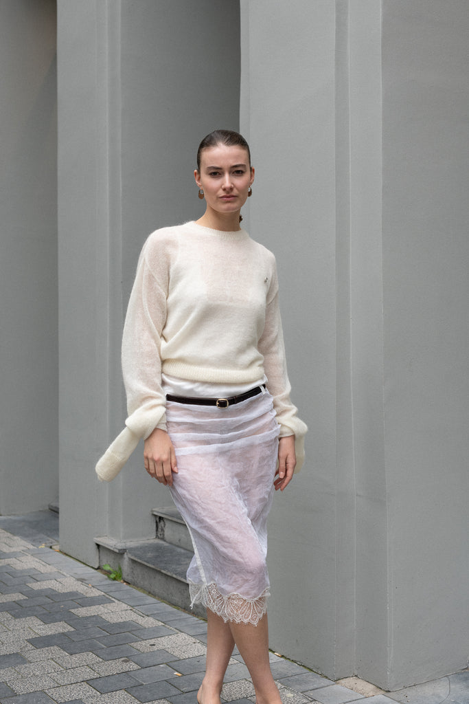 The Knotted Sleeves Polo Jumper by Coperni&nbsp;is a cropped sweater with extra long sleeves which are meant to be tied up in a knot