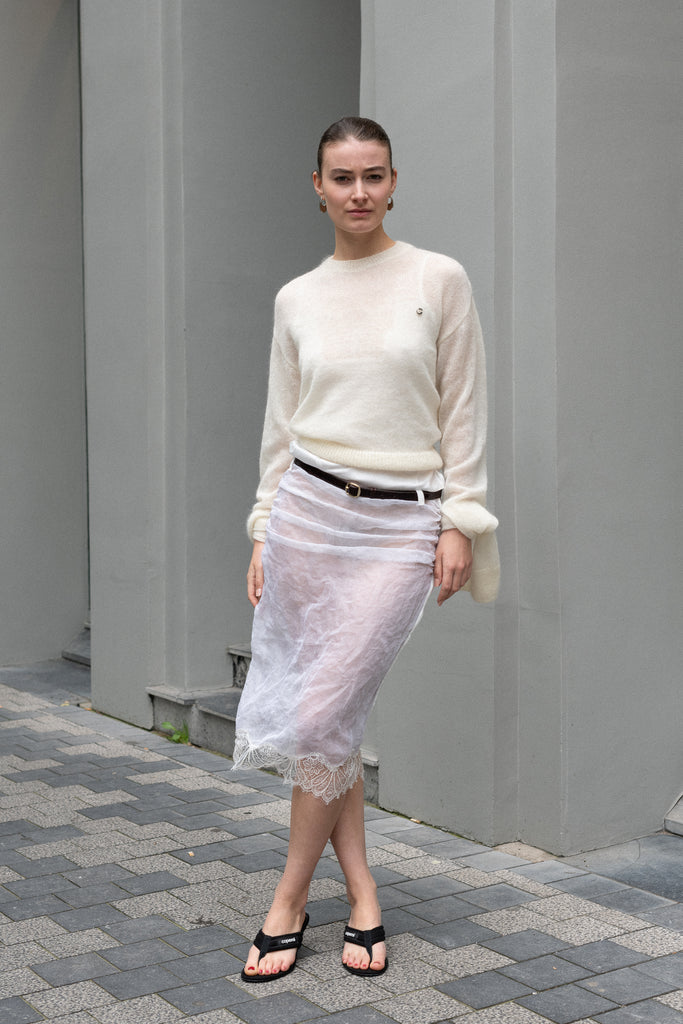 The Knotted Sleeves Polo Jumper by Coperni&nbsp;is a cropped sweater with extra long sleeves which are meant to be tied up in a knotThe Organza Belt Skirt by Coperni&nbsp;is a delicate organza skirt