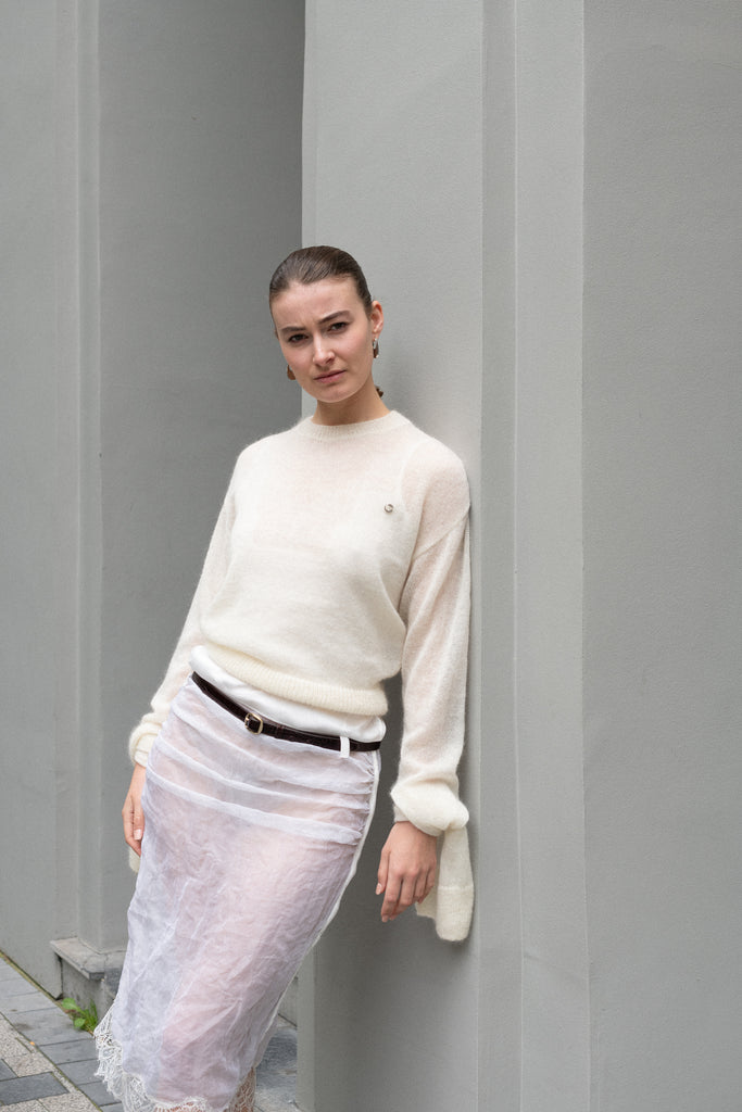 The Knotted Sleeves Polo Jumper by Coperni&nbsp;is a cropped sweater with extra long sleeves which are meant to be tied up in a knot