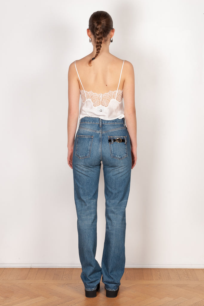 The Straight Denim Pants by Coperni is a straight legged jeans with a high waist and a belted detail on the back pocket