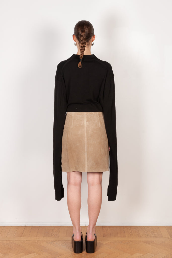 The Suede Skirt by Coperni is a beige suede leather skirt with a contrasted black patent detail