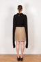 The Suede Skirt by Coperni is a beige suede leather skirt with a contrasted black patent detail