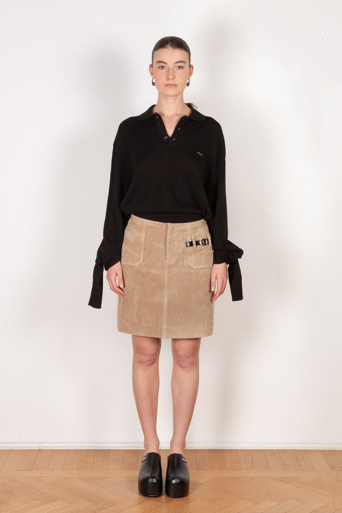 The Suede Skirt by Coperni is a beige suede leather skirt with a contrasted black patent detail