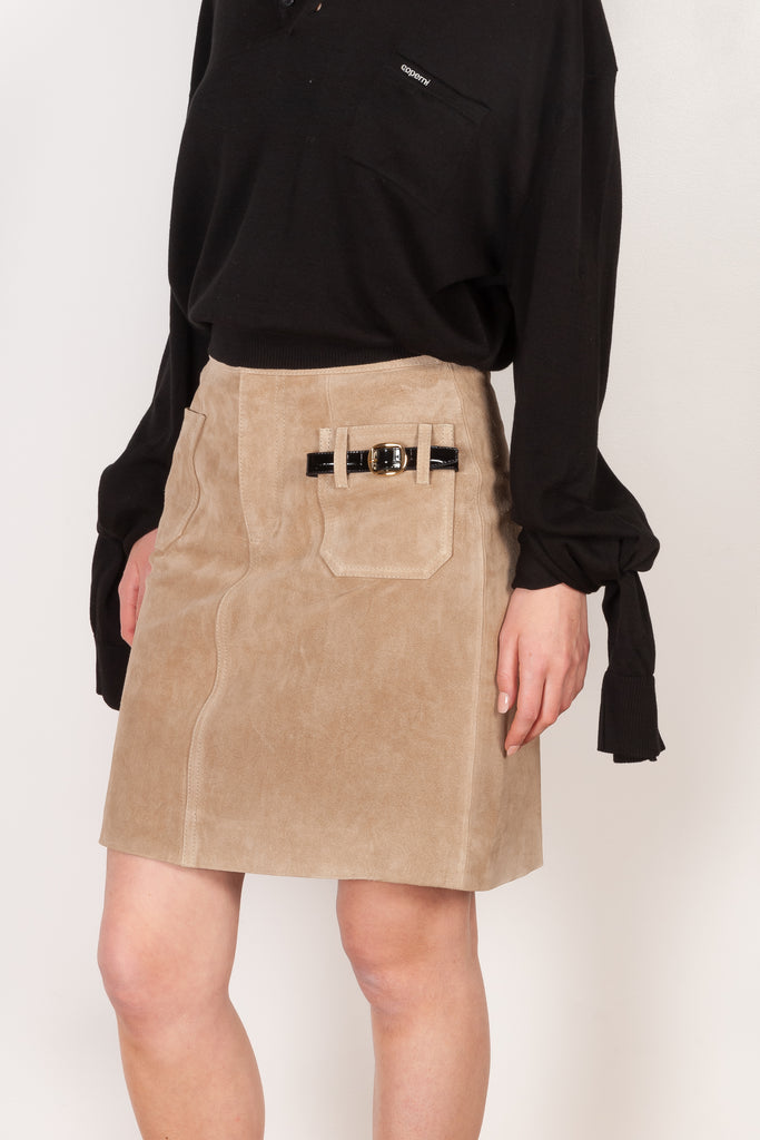 The Suede Skirt by Coperni is a beige suede leather skirt with a contrasted black patent detail