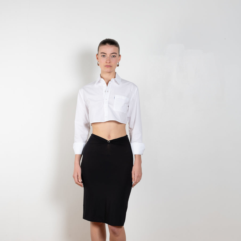 The Triangle Skirt by Coperni is a low waist fine jersey skirt with a small Logo at the te front and a triangle cut-out at the back