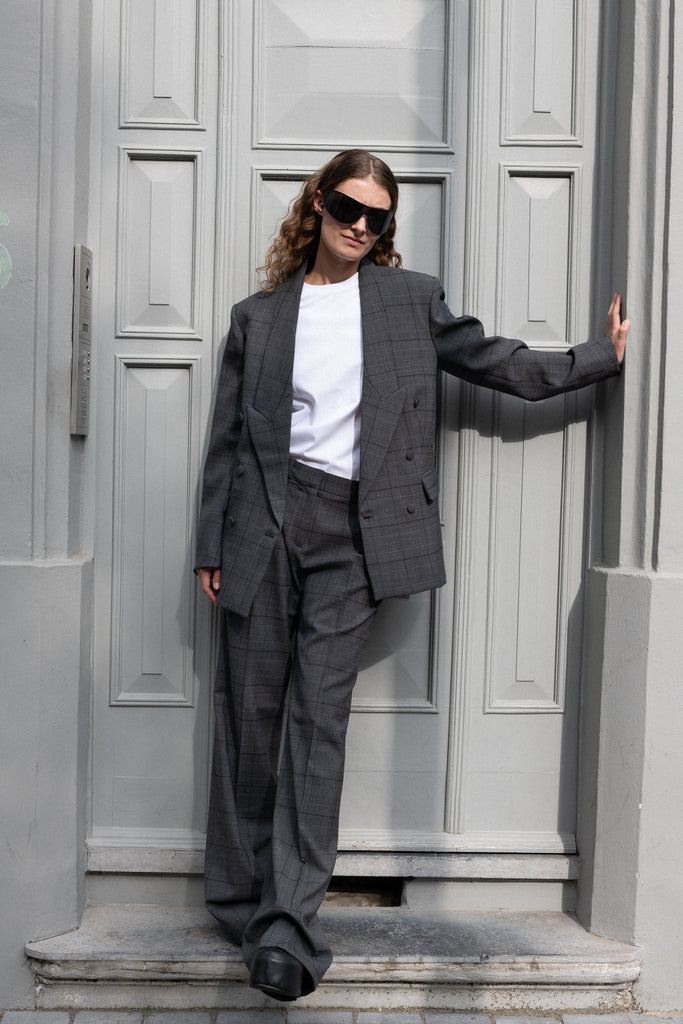 The Tailored Trouser by Coperni is a mid rise trouser with a long fluid wide leg in a seasonal windowpane check