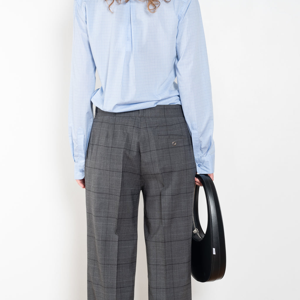 The Tailored Trouser by Coperni is a mid rise trouser with a long fluid wide leg in a seasonal windowpane check