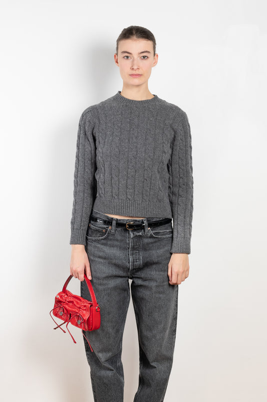 The Carrow Cable Crewneck is a crewneck sweater with a signature cable pattern and a shorter fitted silhouette