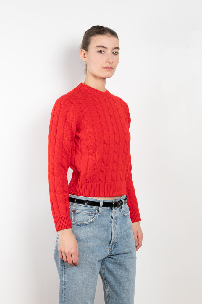 The Carrow Cable Crewneck is a crewneck sweater with a signature cable pattern and a shorter fitted silhouette