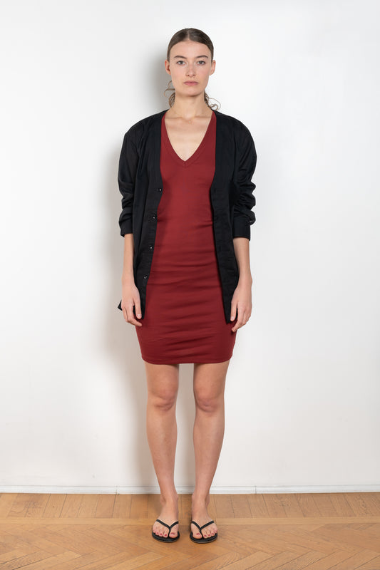 The Dewi Dress by Flore Flore is a fitted crew neck tank dress with a double stitched cut-off seam on the back. 
