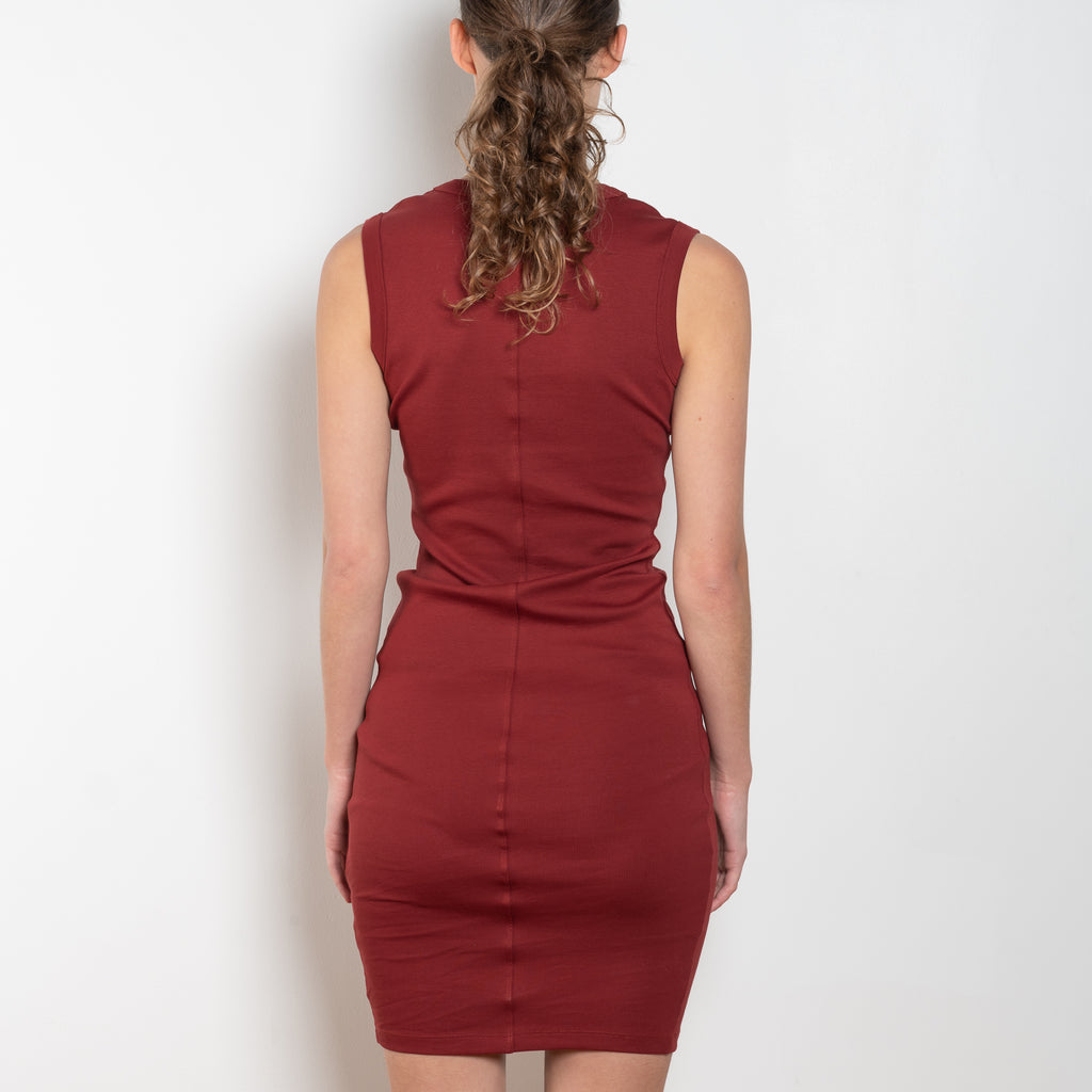 The Dewi Dress by Flore Flore is a fitted crew neck tank dress with a double stitched cut-off seam on the back.