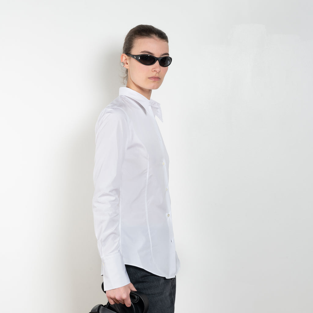 The Giulia Shirt by Flore Flore is a slim fitted shirt with a pointy collar and lengthened single buttoned cuffs with two pleats on the back