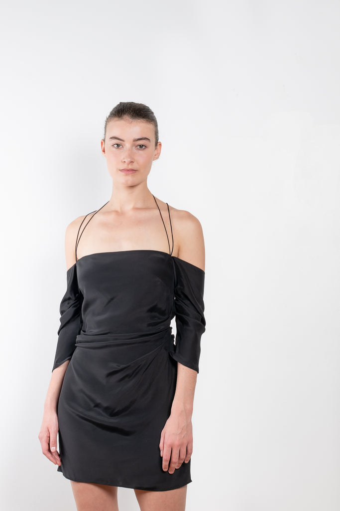 The Samaca Mini Dress by GAUGE81 is a silk off-the-shoulder dress with fine straps both as a halter & crossed back