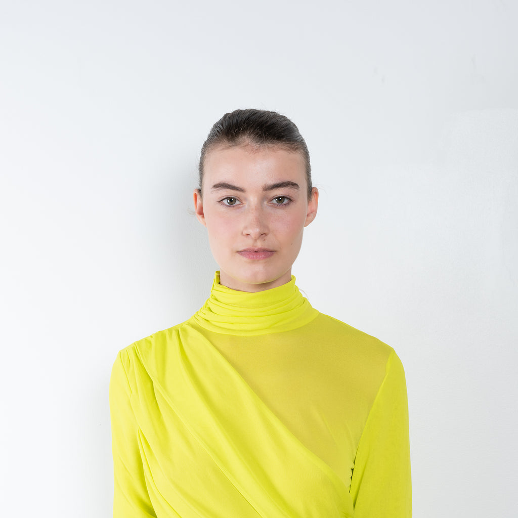 The Ula Dress by Gauge81 is an elegant vibrant yellow dress with draped details in a fine mesh fabric