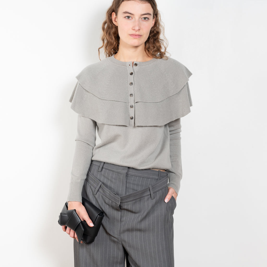 The Aubrey Sweater by Lisa Yang is a feminine cardigan top with a big ruffle detail collar
