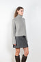 The Fleur Sweater by Lisa Yang has a relaxed silhouette with a loose high neck