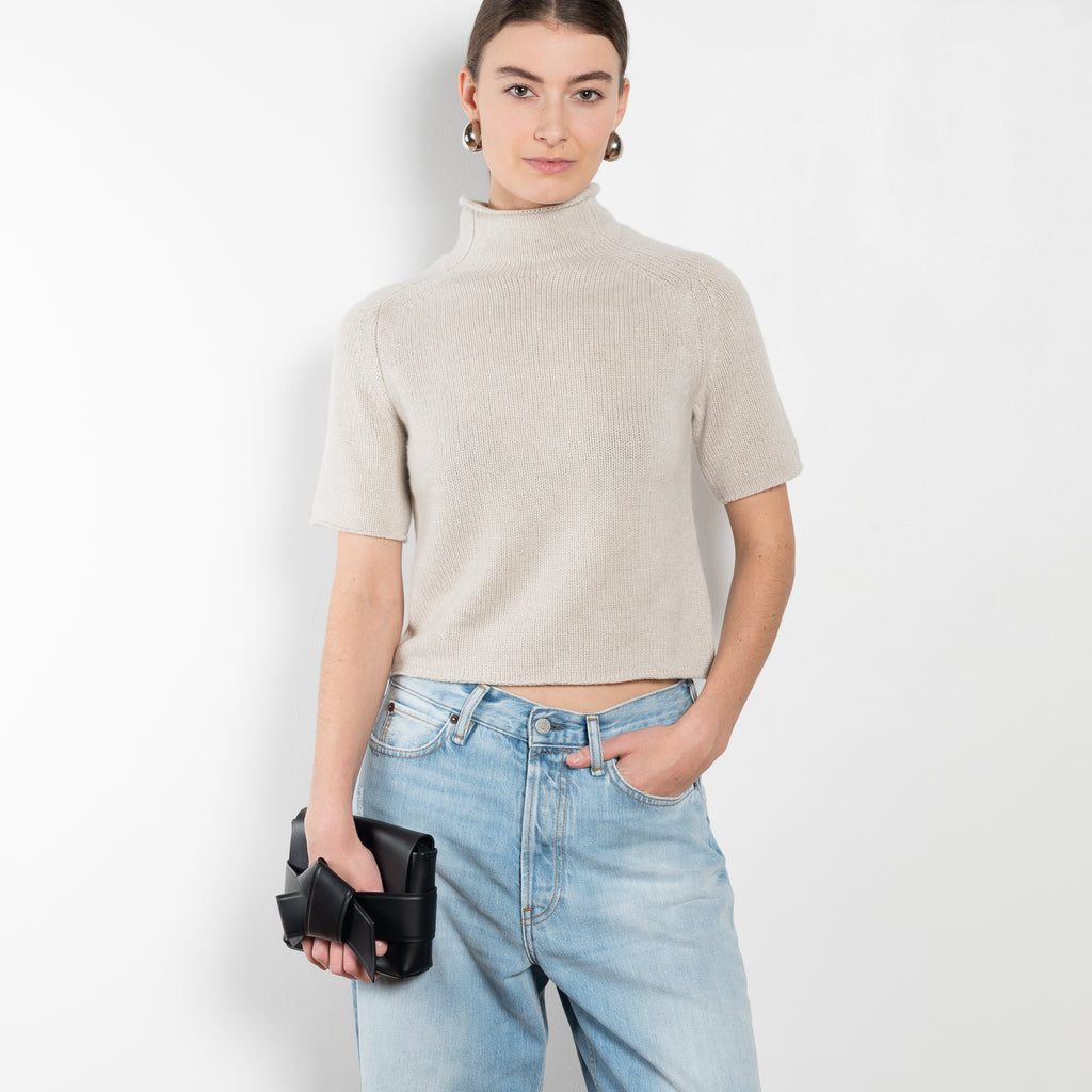 The Fride Sweater by LISA YANG has a standing mock-neck, with flattering, slim short sleeves and a cropped, regular fit.