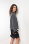The Sandy Sweater by LISA YANG has a straight fit with dropped shoulders and a raw hem mock neck
