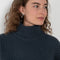 The Julina Sweater by LISA YANG is a chuncky cashmere ribbed sweater with a high neck and straight fit