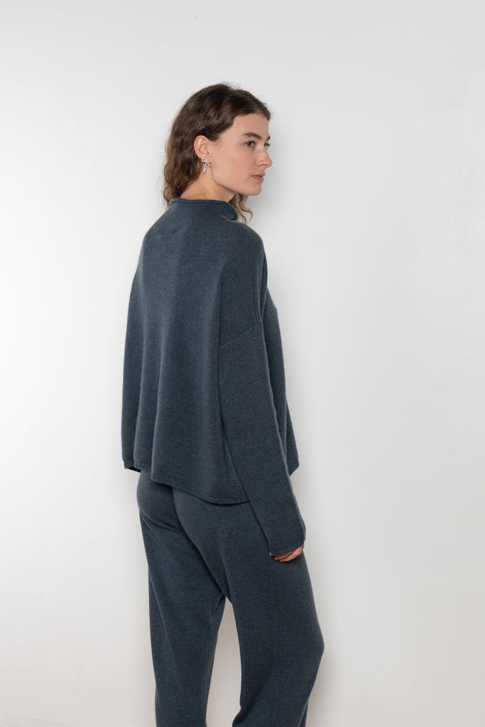 The Sandy Sweater by LISA YANG has a straight fit with dropped shoulders and a raw hem mock neck