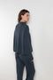 The Sandy Sweater by LISA YANG has a straight fit with dropped shoulders and a raw hem mock neck