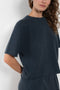 The Cila Tee by LISA YANG is a fine knit cashmere t-shirt with a classic round neck and rolled trim edges