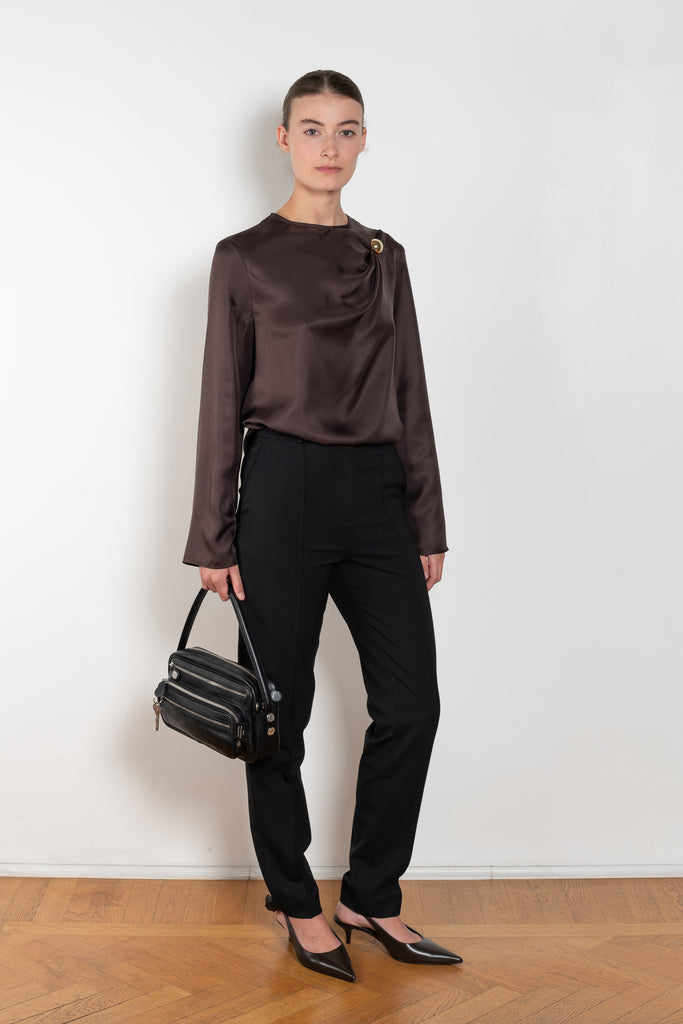 The Azae Blouse by Loulou Studio is a refined silk twill blouse with a draped detail and hardware embellishment