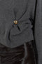 The Bill Sweater by Loulou Studio is thick soft cashmere sweater with a draped detail and an hardware embellishment