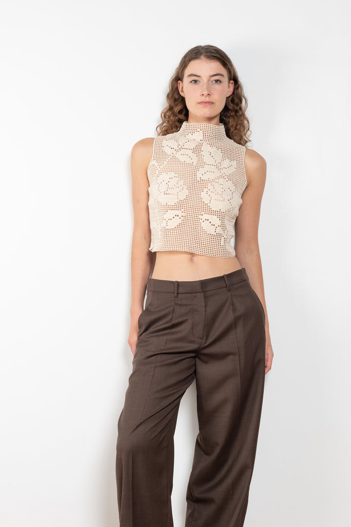 The Crochet Lace Top by Magda Butrym is a cropped top with a high neck and an all-over floral design in traditional Polish crochet technique