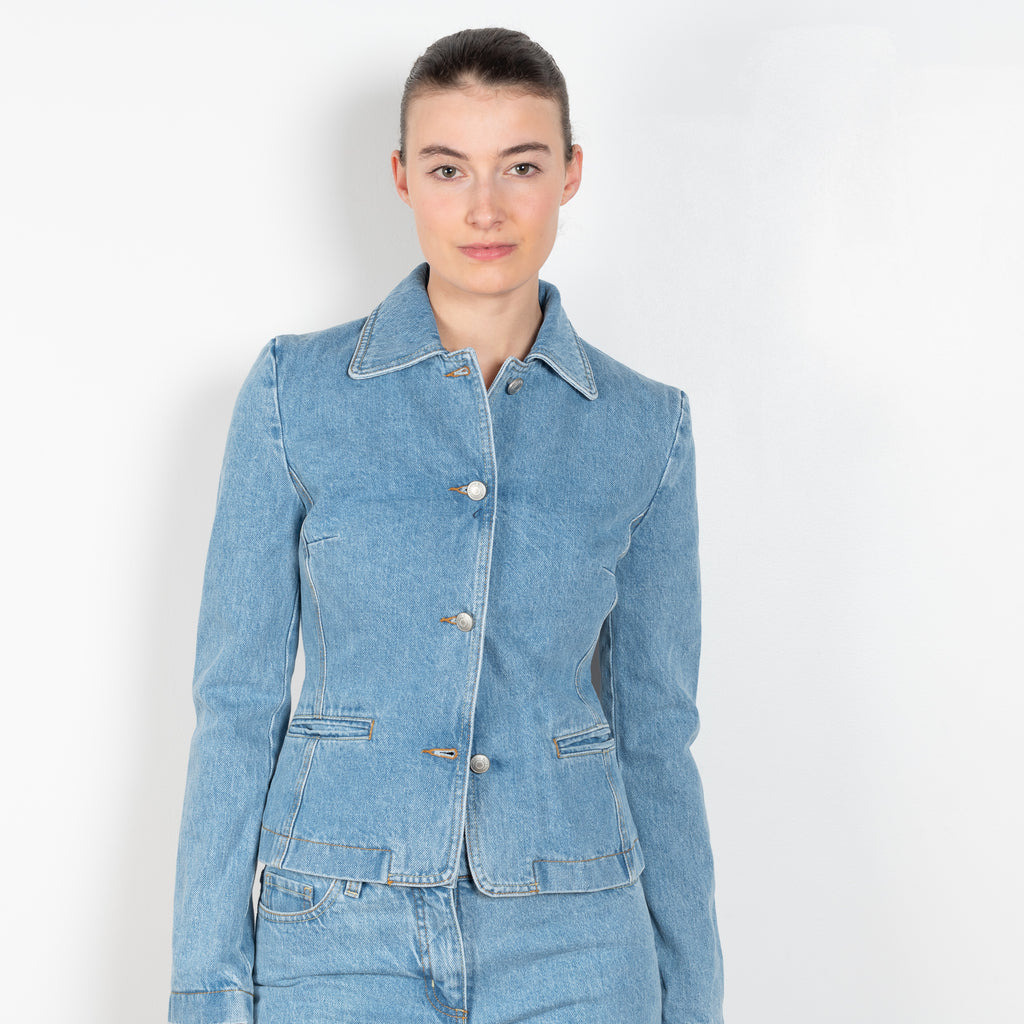 The Denim Blazer by Magda Butrym is a signature fitted denim jacket in a structured cotton with a peplum fit