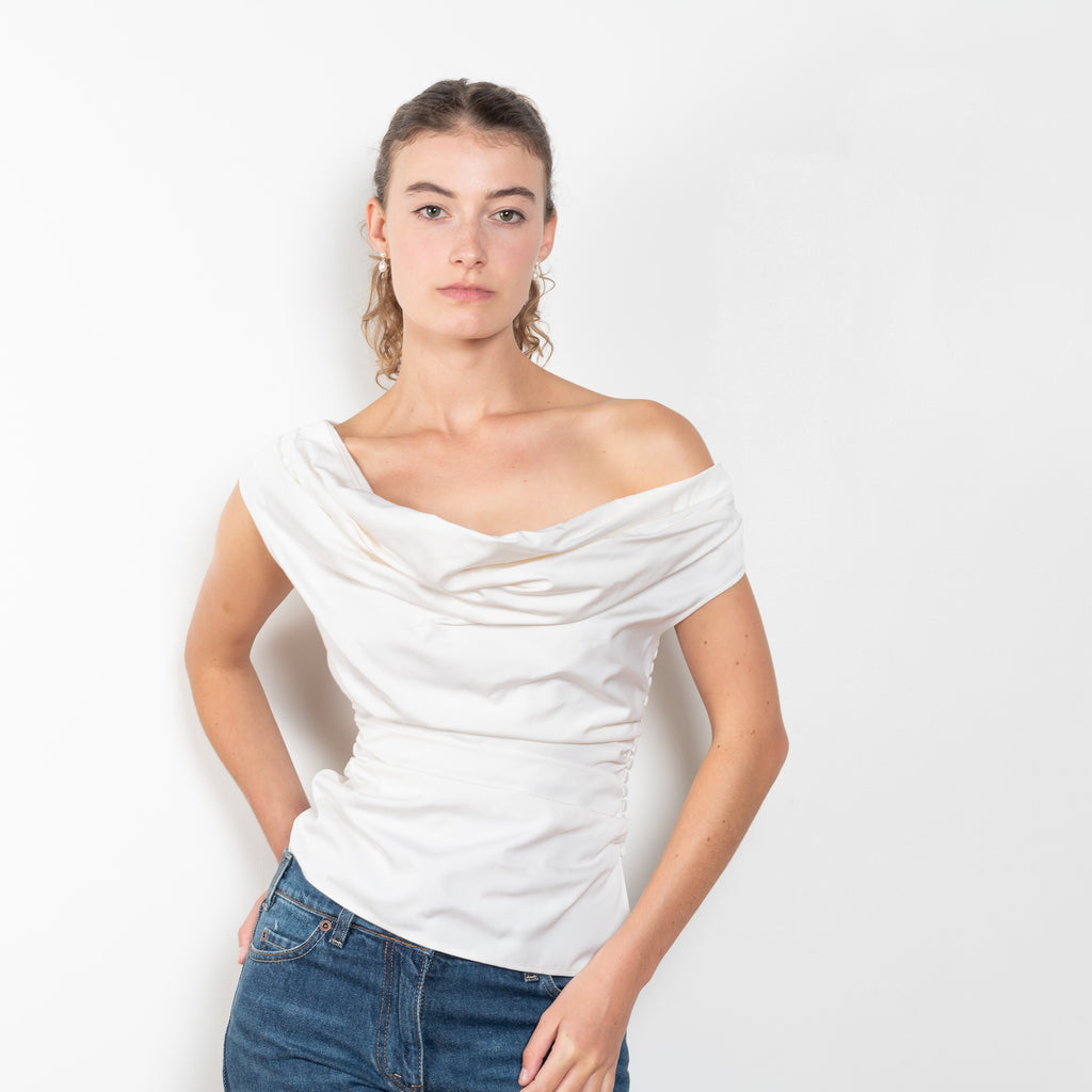 The Off Shoulder Draped Top by Magda Butrym is made from natural crinkle silk and has a draped wrap effect and side ruching down the body for an elegant fit