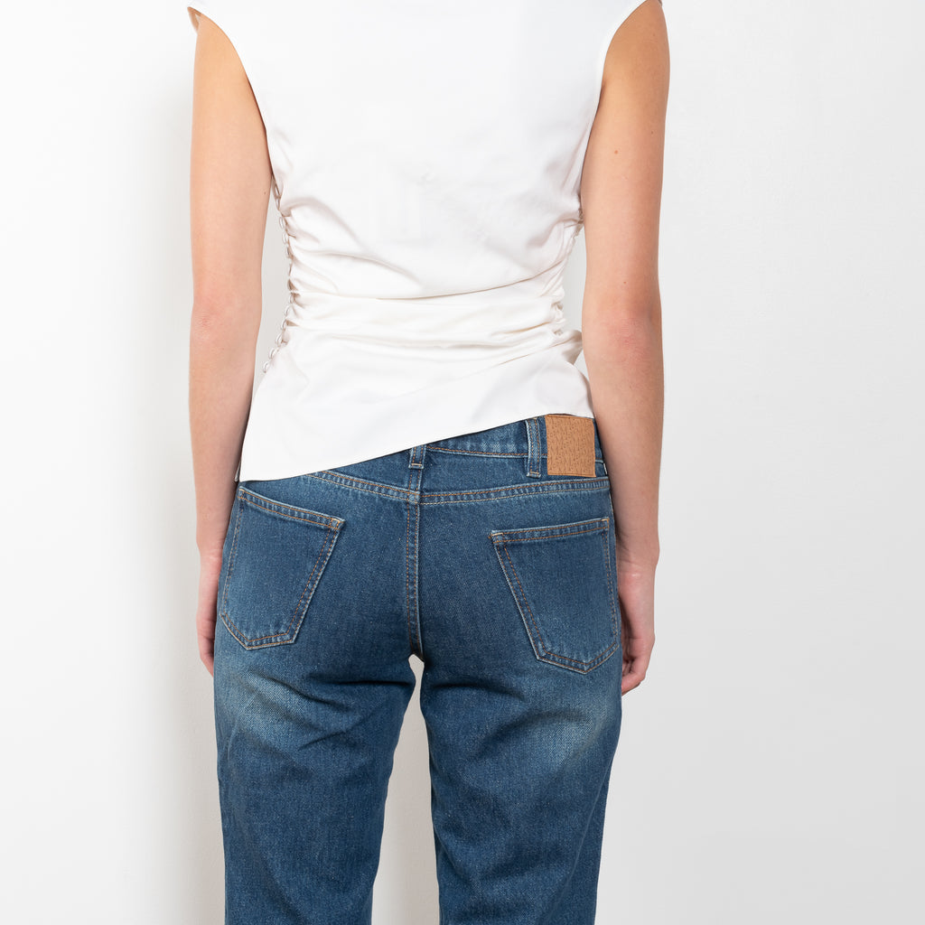 The Flare Denim by Magda Butrym is a low waist, rigid cotton denim with elongated flare legs