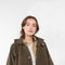 The Parka Coat Oil by Maud Van Den Beussche is a long parka in a structured cotton with detachable hood