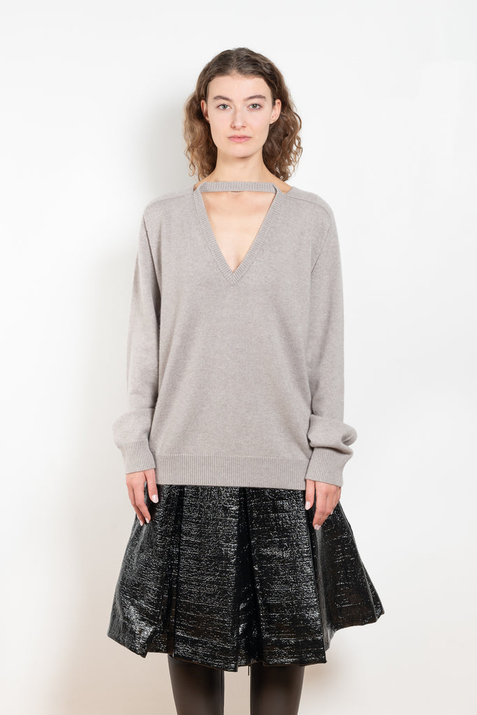 The Cut-out Vneck Sweater by Meryll Rogge is an oversized cashmere sweater with cut-outs at the arms and a deconstructed neckline which can be worn back or front