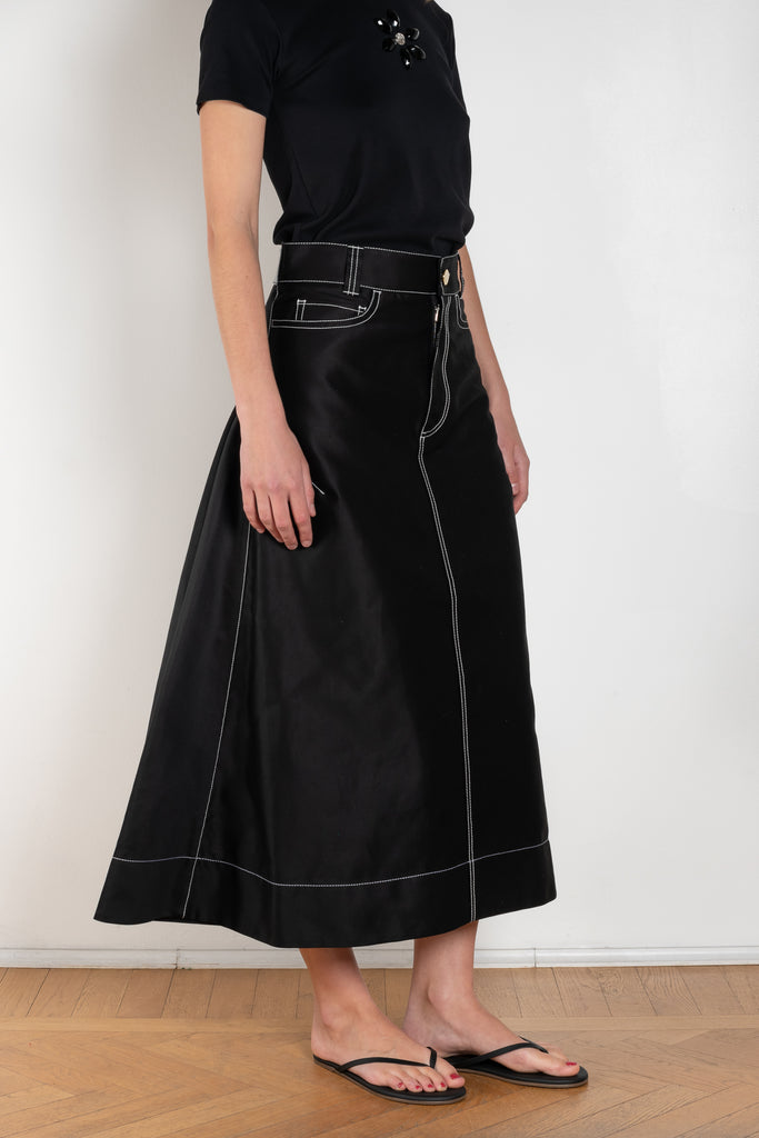 The Flared Workwear Skirt by Meryll Rogge is a long cotton skirt with a flat front and flared fit on the back