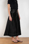 The Flared Workwear Skirt by Meryll Rogge is a long cotton skirt with a flat front and flared fit on the back