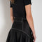 The Flared Workwear Skirt by Meryll Rogge is a long cotton skirt with a flat front and flared fit on the back