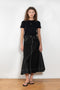The Flared Workwear Skirt by Meryll Rogge is a long cotton skirt with a flat front and flared fit on the back