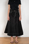 The Flared Workwear Skirt by Meryll Rogge is a long cotton skirt with a flat front and flared fit on the back