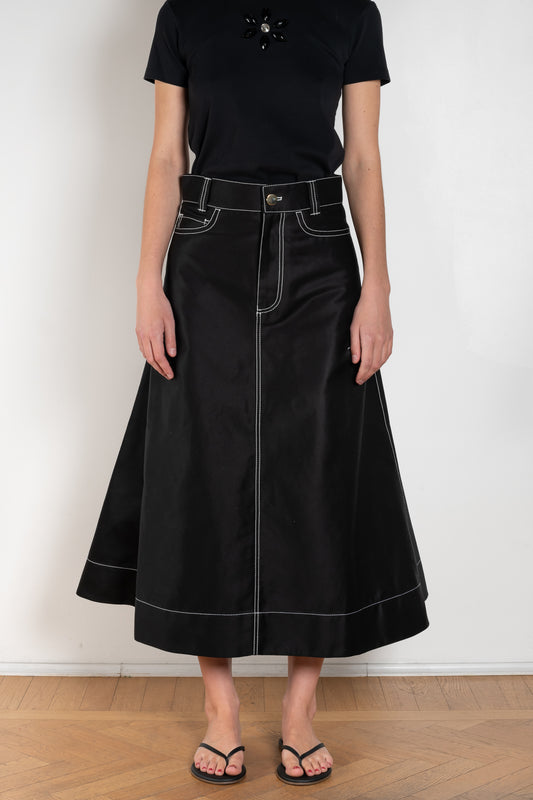 The Flared Workwear Skirt by Meryll Rogge is a long cotton skirt with a flat front and flared fit on the back