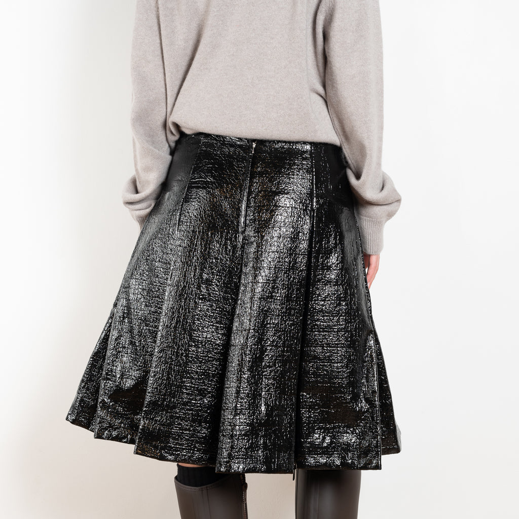 The Lacquered Pleated Skirt by Meryll Rogge is mid waist pleated skirt in lacquered coated cotton