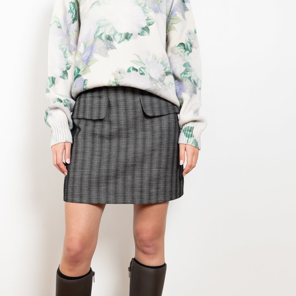 The Tailored Skirt by Meryll Rogge is a high waisted tailored mini skirt with front flap pockets