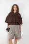 The Ruffle Tiered Top by Meryll Rogge is a crisp cotton top with layered ruffles that can be tucked into your trousers